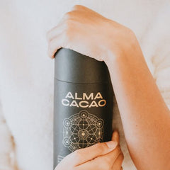 Holding a tin of Alma Cacao close