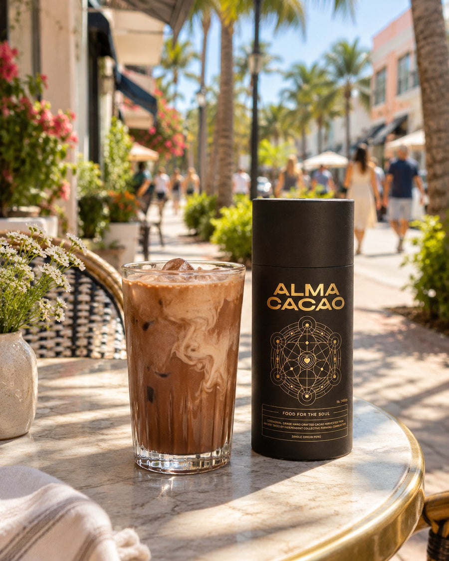 An iced cacao and the Alma Cacao canister on a café table along Atlantic Avenue in Delray Beach