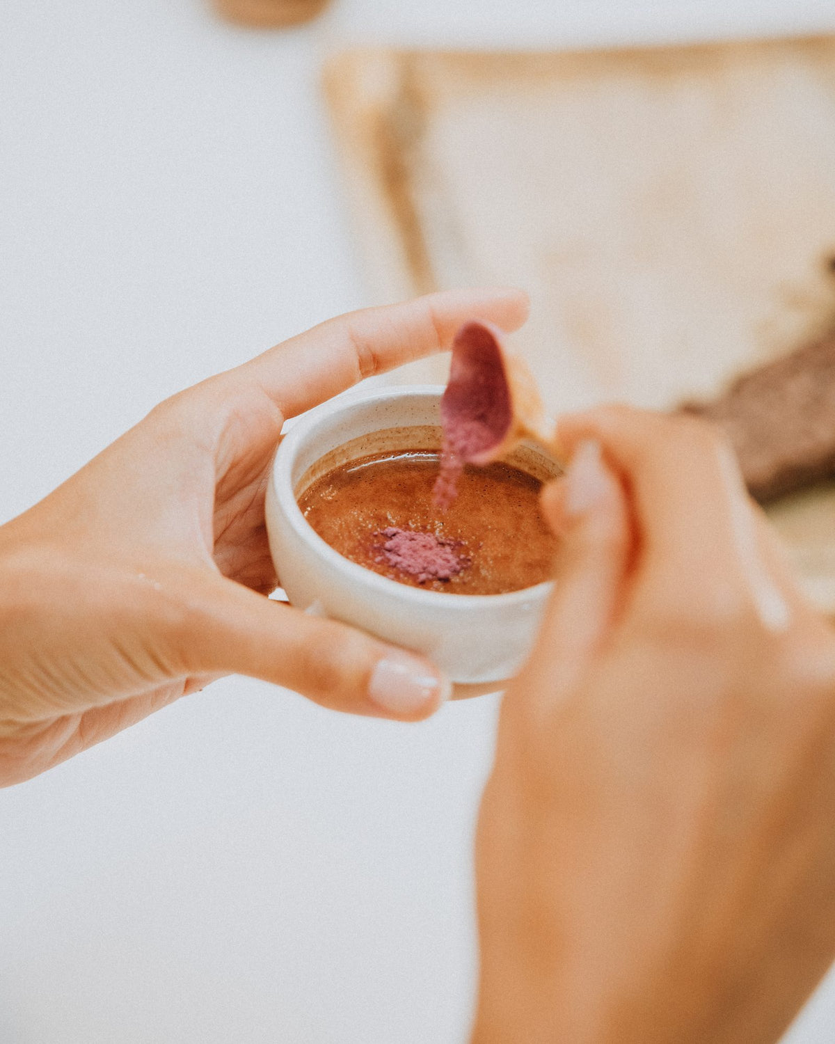 Hands holding a cup of ceremonial cacao